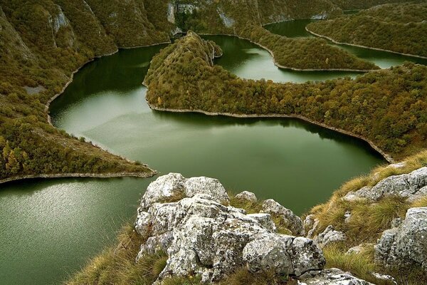 Winding river in a grassy quarry