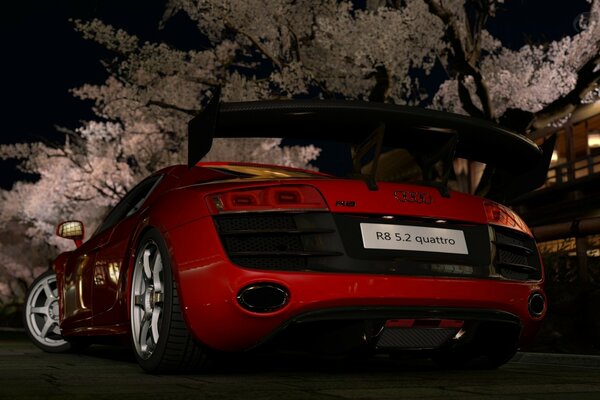 Red Audi car at night against the background of trees