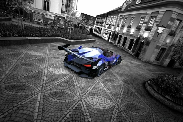 Blue racing car in grey city