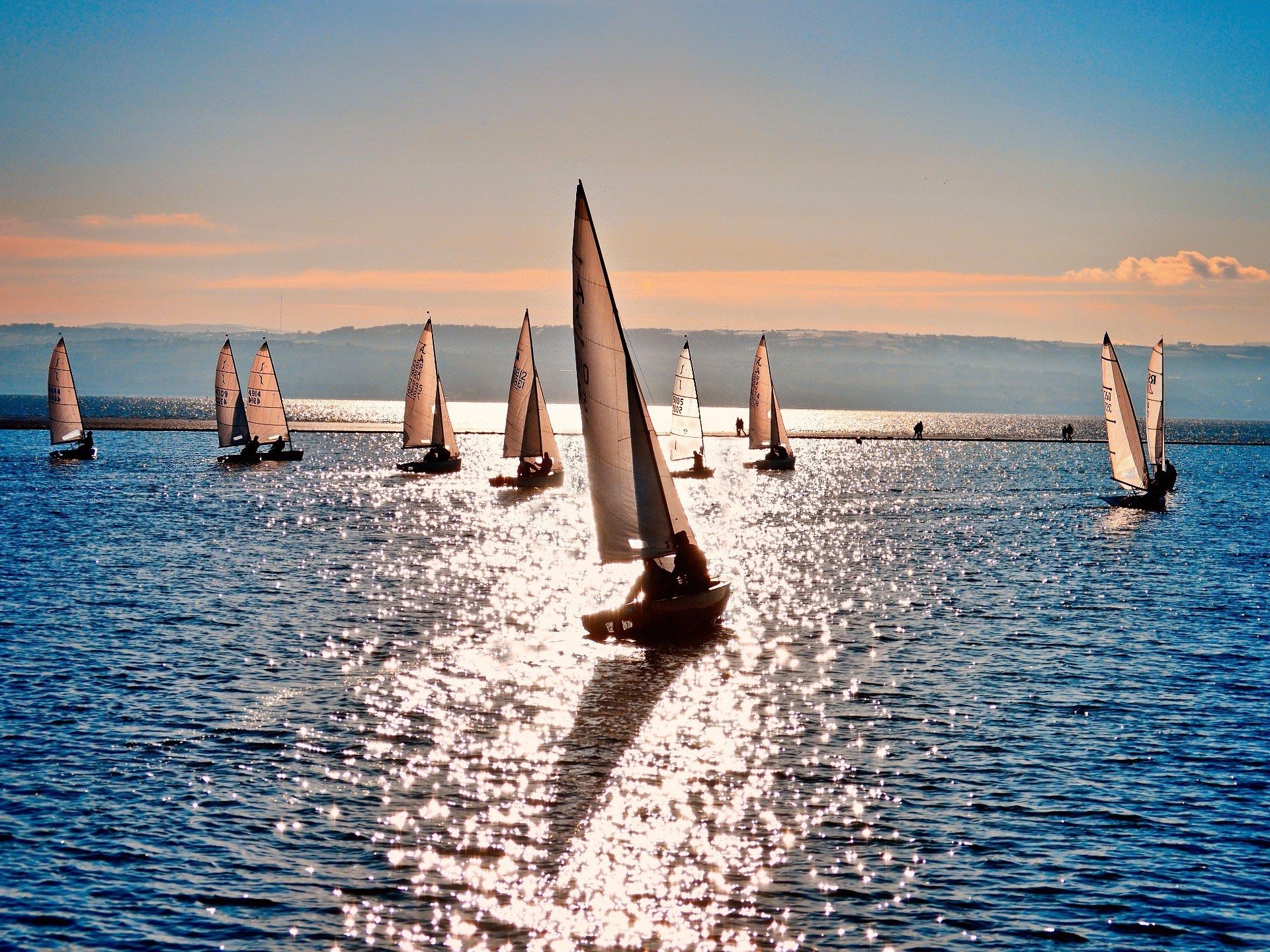 sailing water sea ocean sailboat travel sky summer beach watercraft sunset sun yacht seashore outdoors boat leisure recreation reflection ship