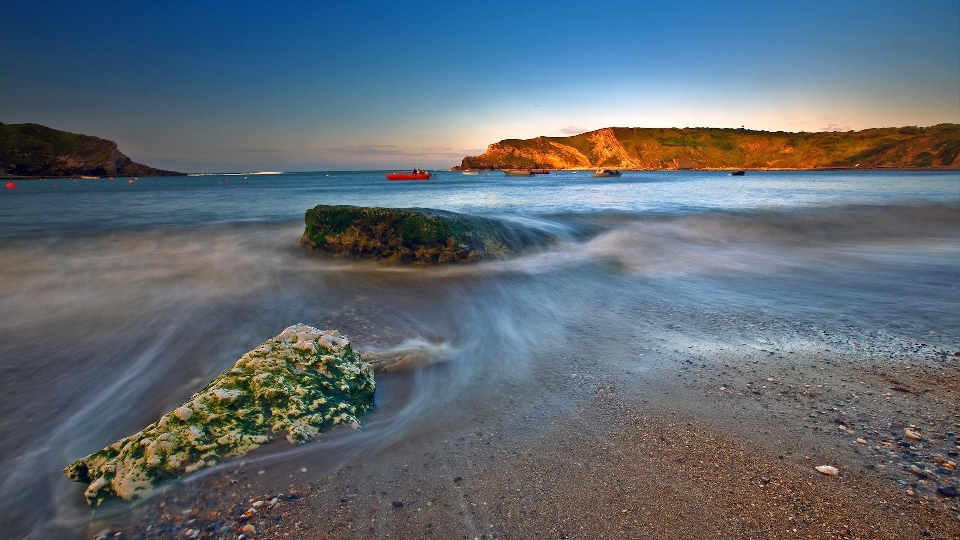 rocks boulders and stones beach water seashore sea travel sunset landscape ocean seascape sand sky nature surf island