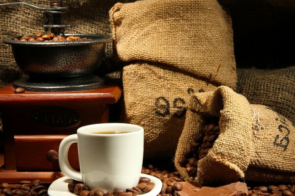 A cup of fragrant coffee near a bag of coffee beans