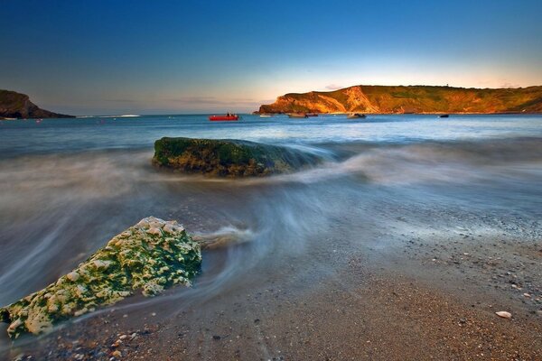 Boulders and rocks on a sandy beach. Beautiful landscape