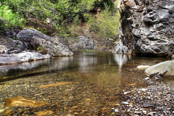 Huge boulders at the bottom of a shallow river