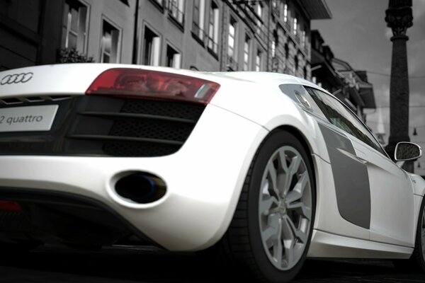 Audi R8 quattro blanco en el fondo de una ciudad nublada en el juego de ordenador gran turismo