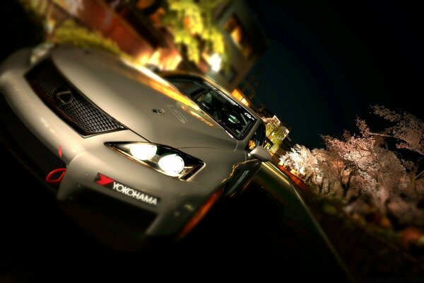 A beige sports car driving on a night road