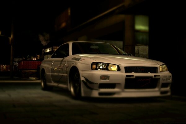 A white car with a low landing is waiting for its night passengers