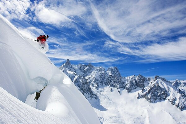 Extreme skier rushing from snowy mountains