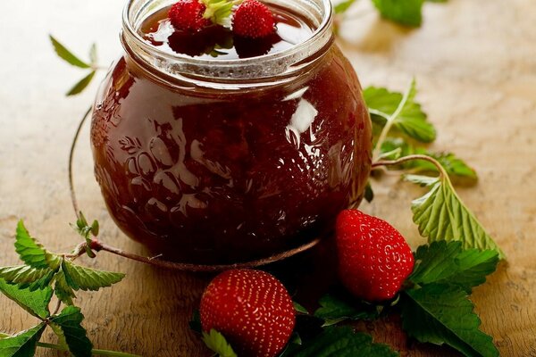 Fruit jam with strawberries in a jar