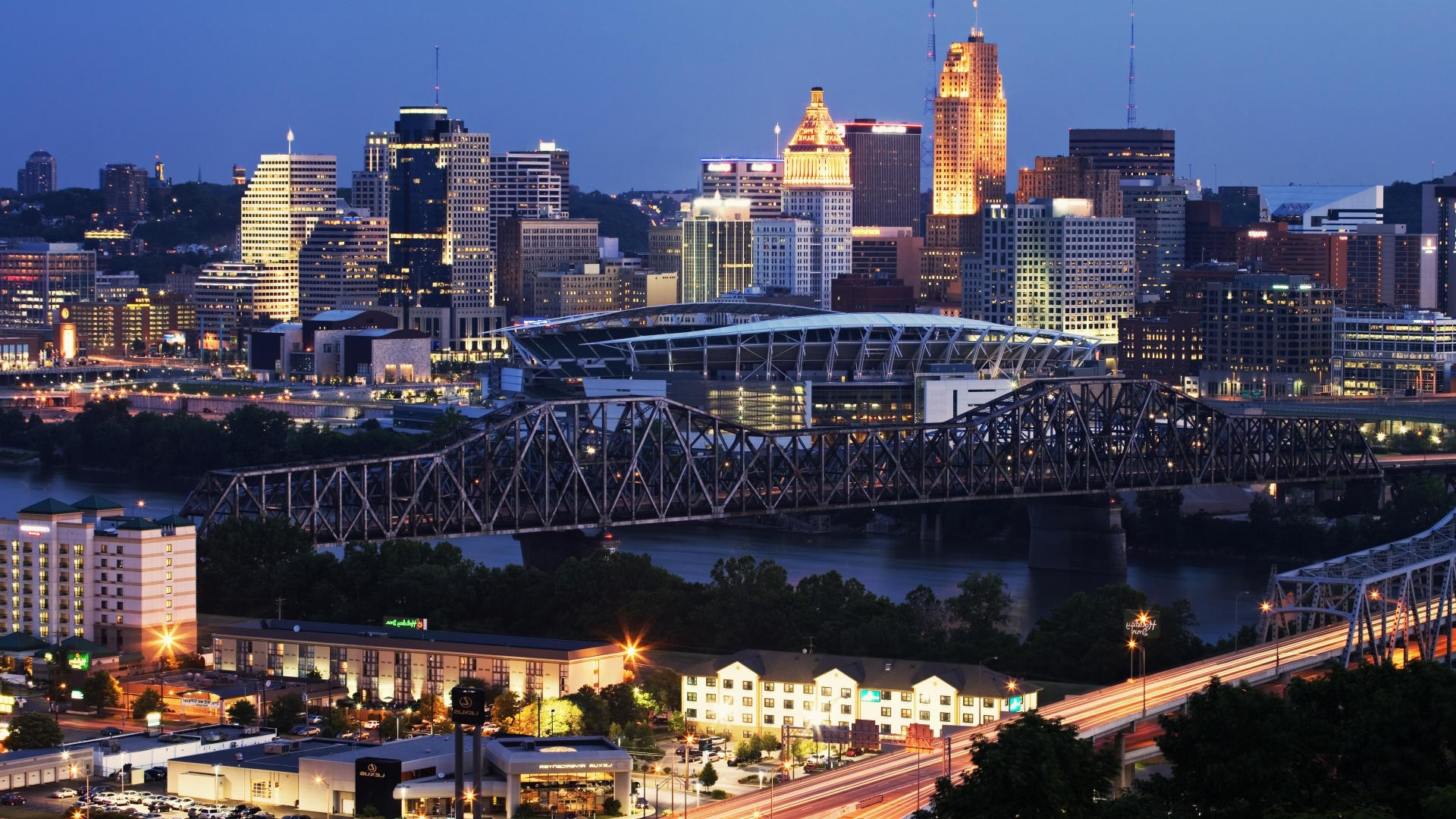 city cityscape bridge travel skyline building skyscraper architecture dusk evening river urban traffic transportation system downtown modern road sky office business