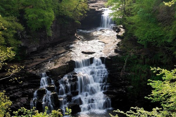 Beautiful stepped waterfall with rocks and rifts