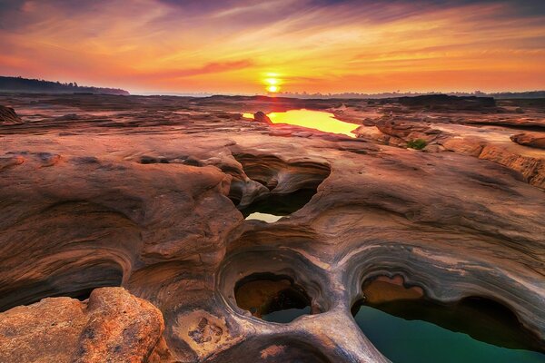 Sunset of the orange sun with reflection in the water