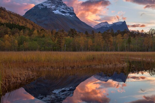 Lake and mountains on sunset background