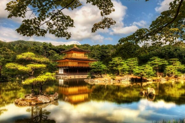 A Chinese-style house on a lake in the middle of trees