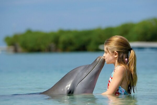 A girl with a dolphin. Summer. Nature