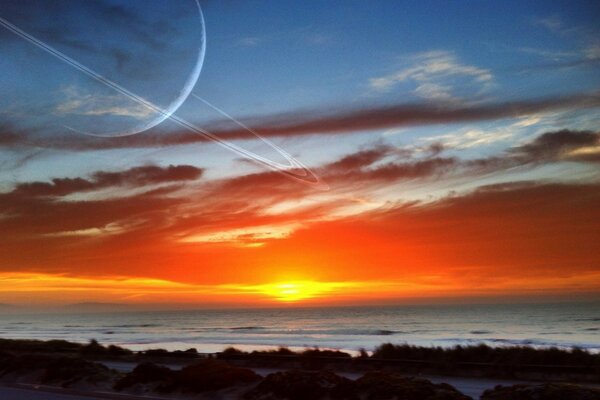 Coucher de soleil au bord de la mer avec vue sur Saturne