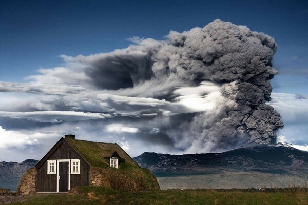 A massive cloud over a house in the mountains