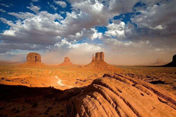 Desert landscape at sunset under clouds