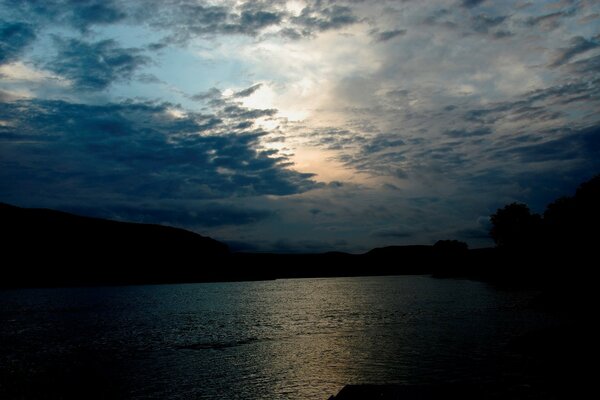 Evening twilight over water and mountains