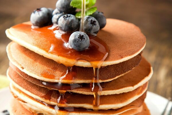 Pancakes for breakfast with wedge syrup and blueberries