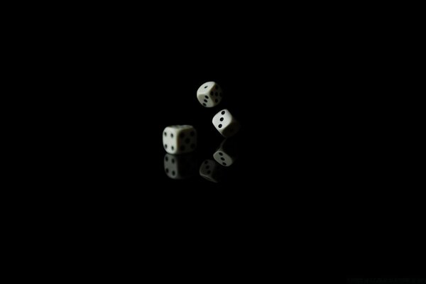 A roll of dice on a black background