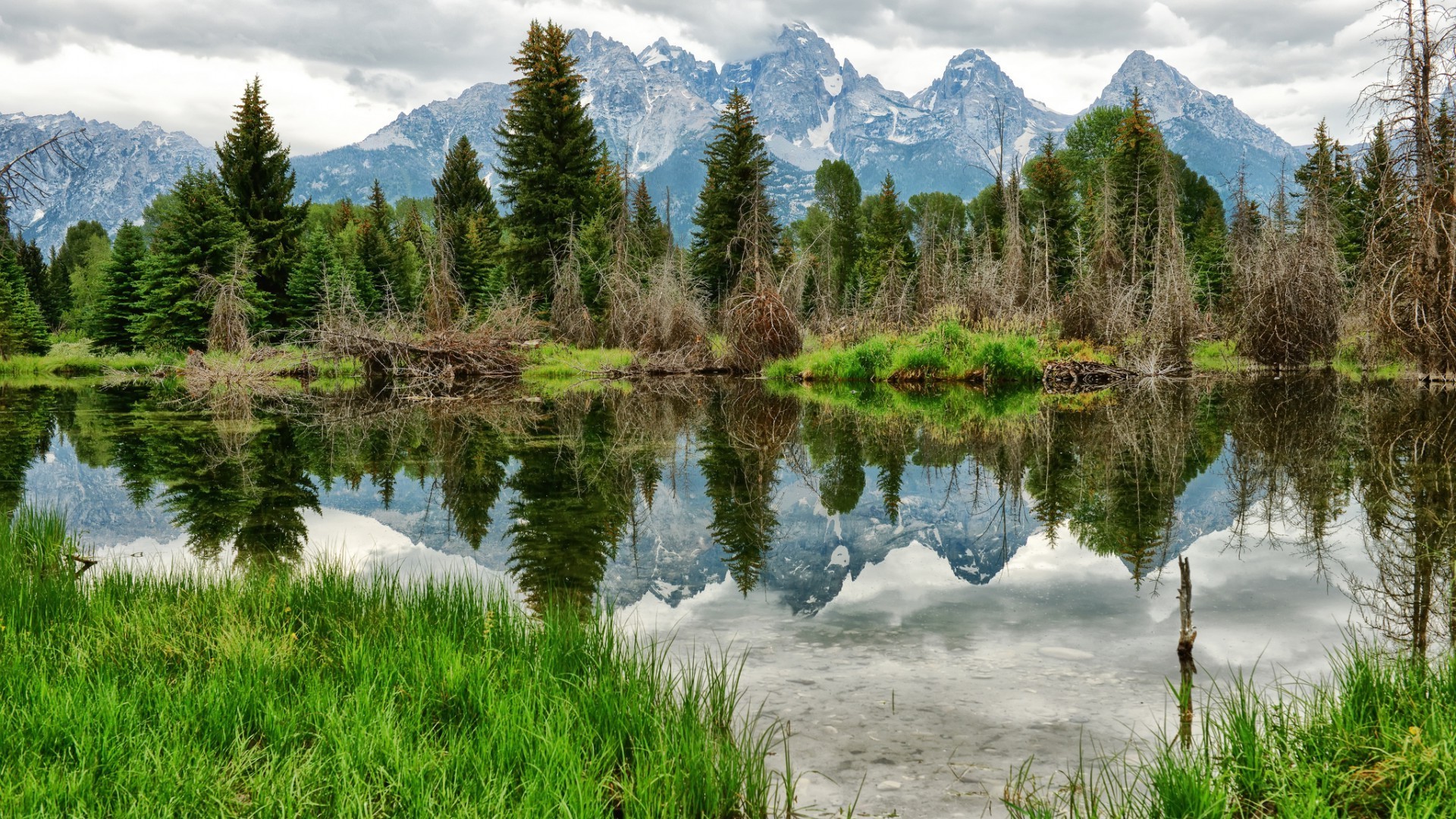 lake nature landscape reflection water mountain scenic outdoors wood sky grass summer travel scenery