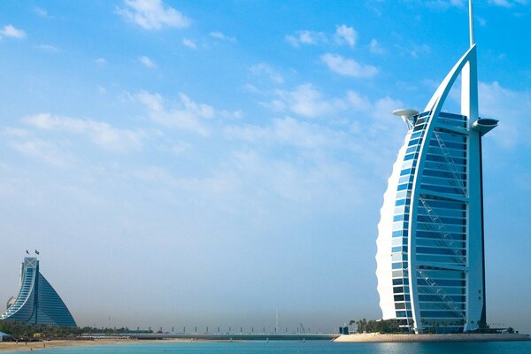 A tall hotel building on an artificial island