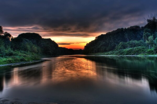 River on the background of a sunset cloudy sky