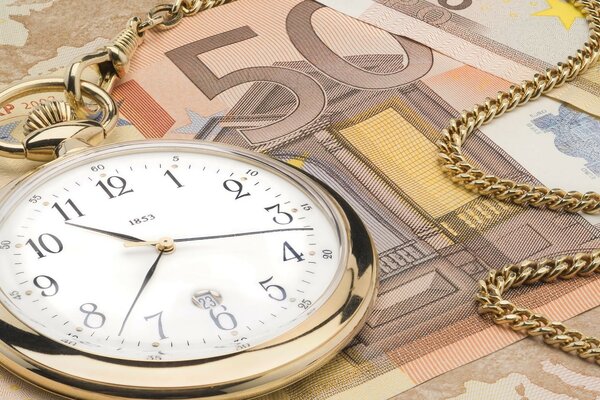 The gold watch is on the banknote