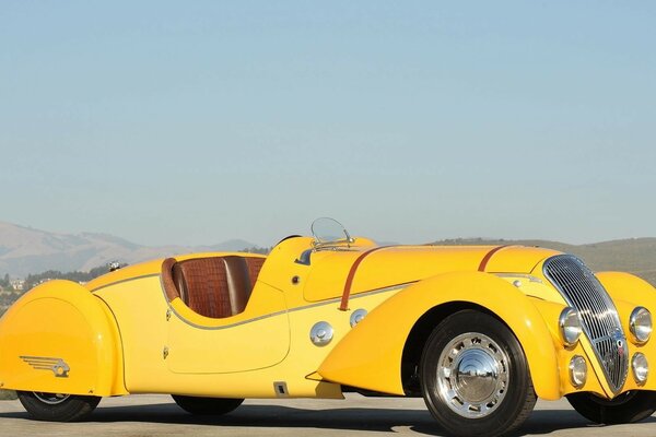 Yellow retro car in the sun