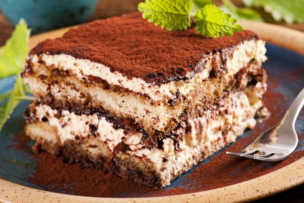 Layered cake on a plate with a fork