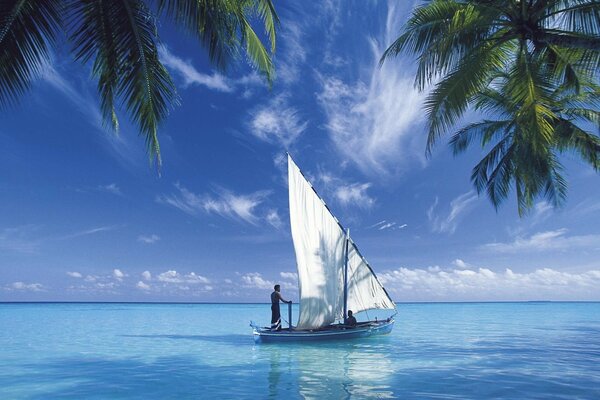 Sailboat in the ocean with a blue sky