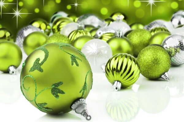 New Year s green and silver balls on a white background