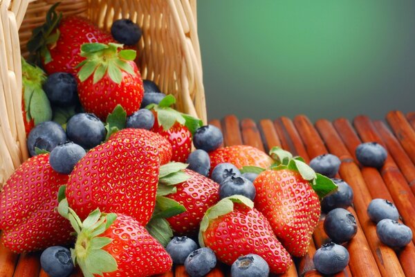 Strawberries and blueberries spilled out of the basket