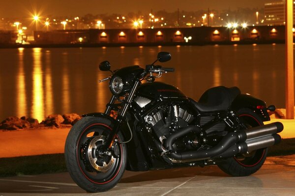 A classic motorcycle stands on the sidewalk