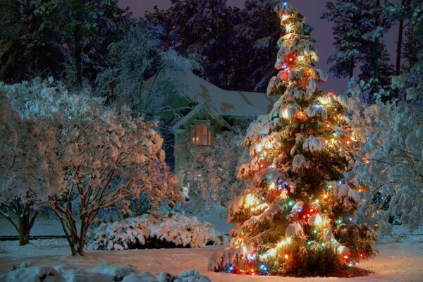 A Christmas tree sparkling with garlands in the New Year s forest