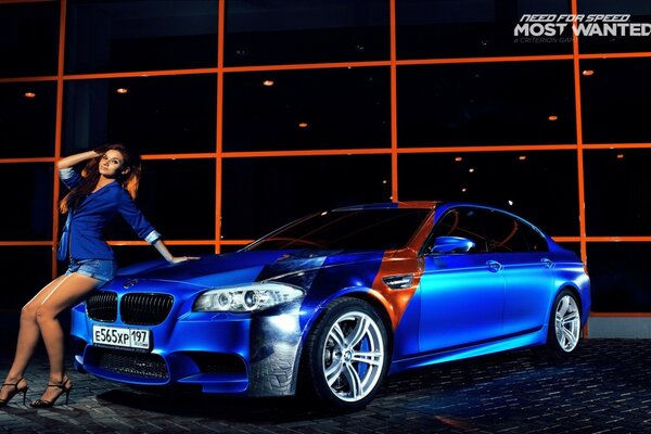 Beautiful girl on the bumper of a blue BMW