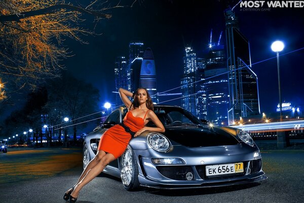 A girl and a car on the background of a night city