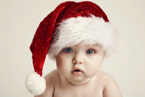 An innocent little child in a Christmas hat