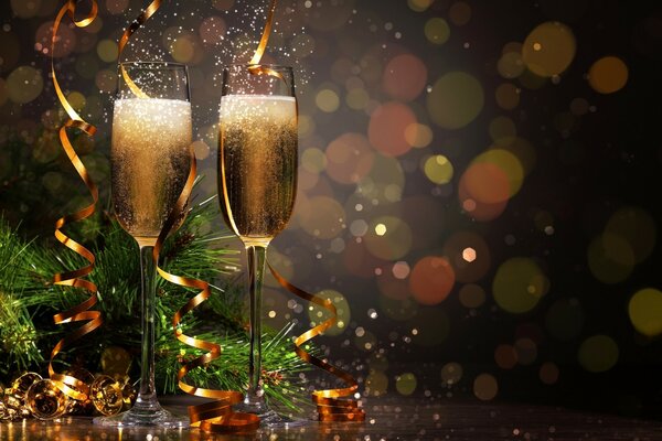 Two glasses of champagne on a background of lights