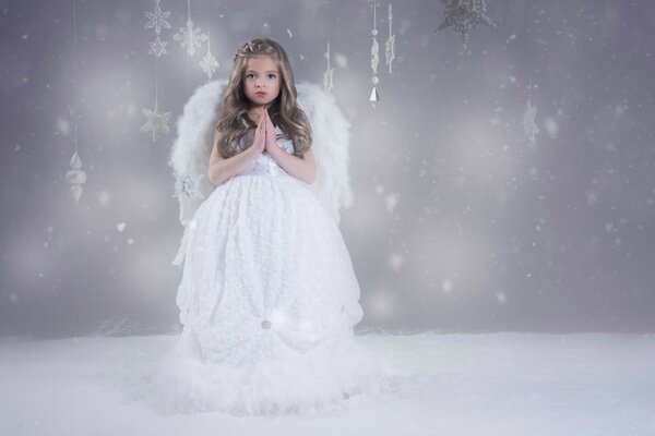 Angel on the background of snow