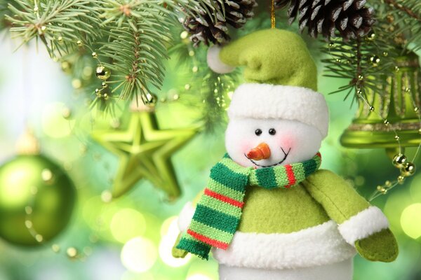 A toy snowman in a green scarf