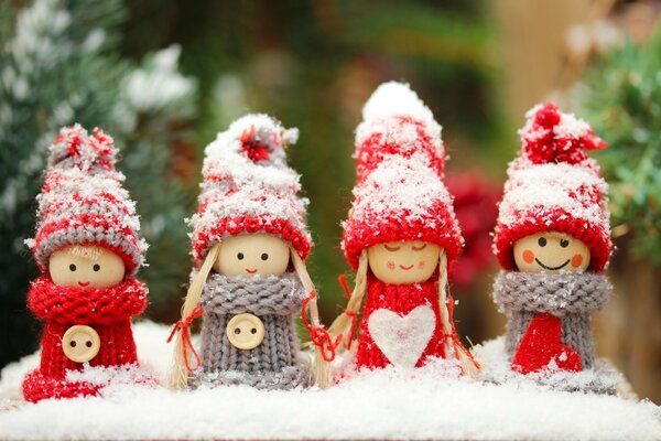 Christmas dolls in hats in the snow