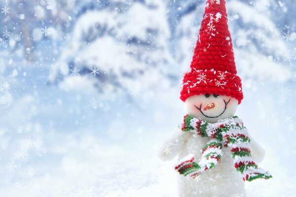 A snowman in a red hat and scarf