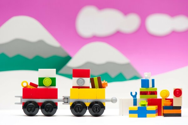 Steam locomotive with gifts on the background of mountains