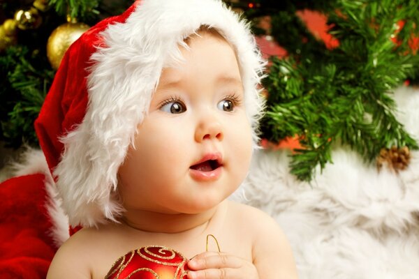 Baby holding a Christmas toy