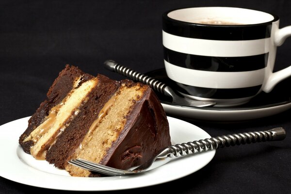 A cup with a cake on a black table