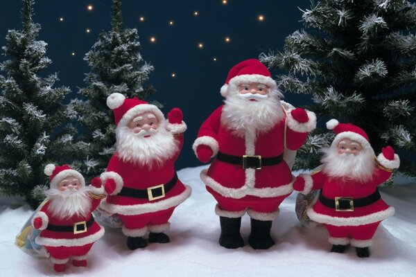 Santa family on the background of fir trees