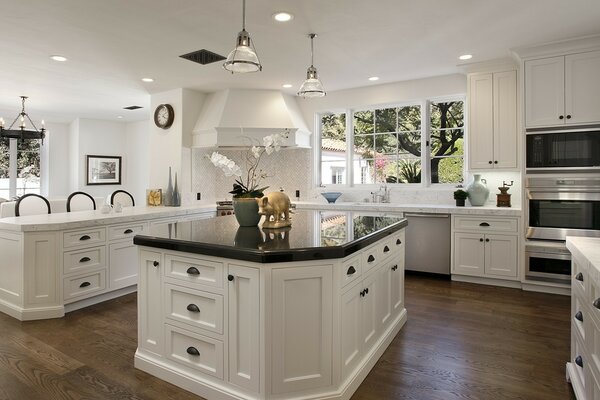 Furnished white kitchen with windows and islands