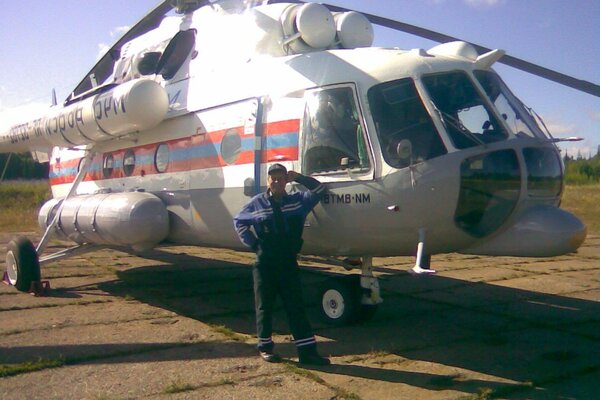 A man near a rescue helicopter at the airfield